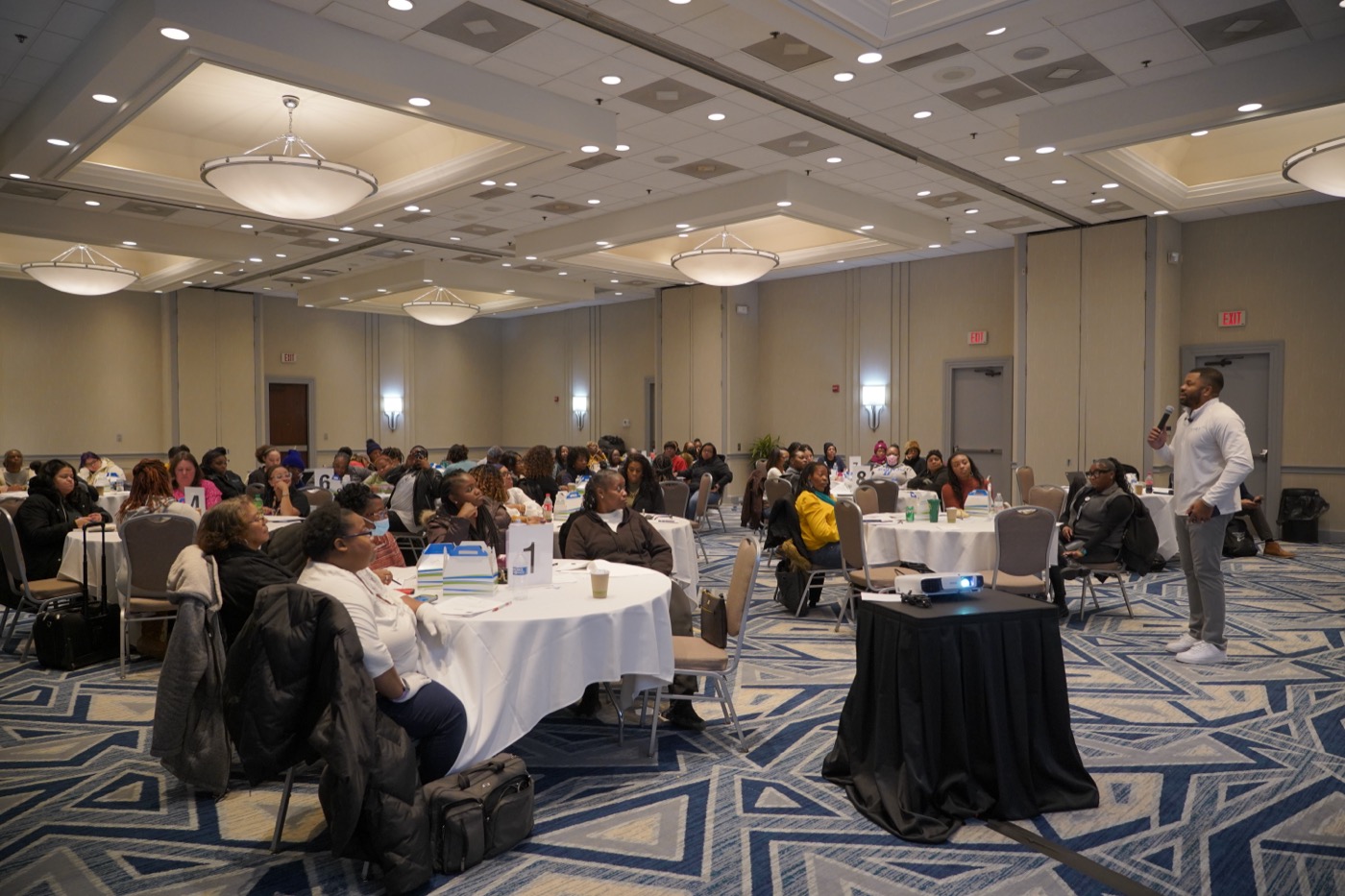 Chris Marvel delivering mental health keynote on stage at corporate conference event